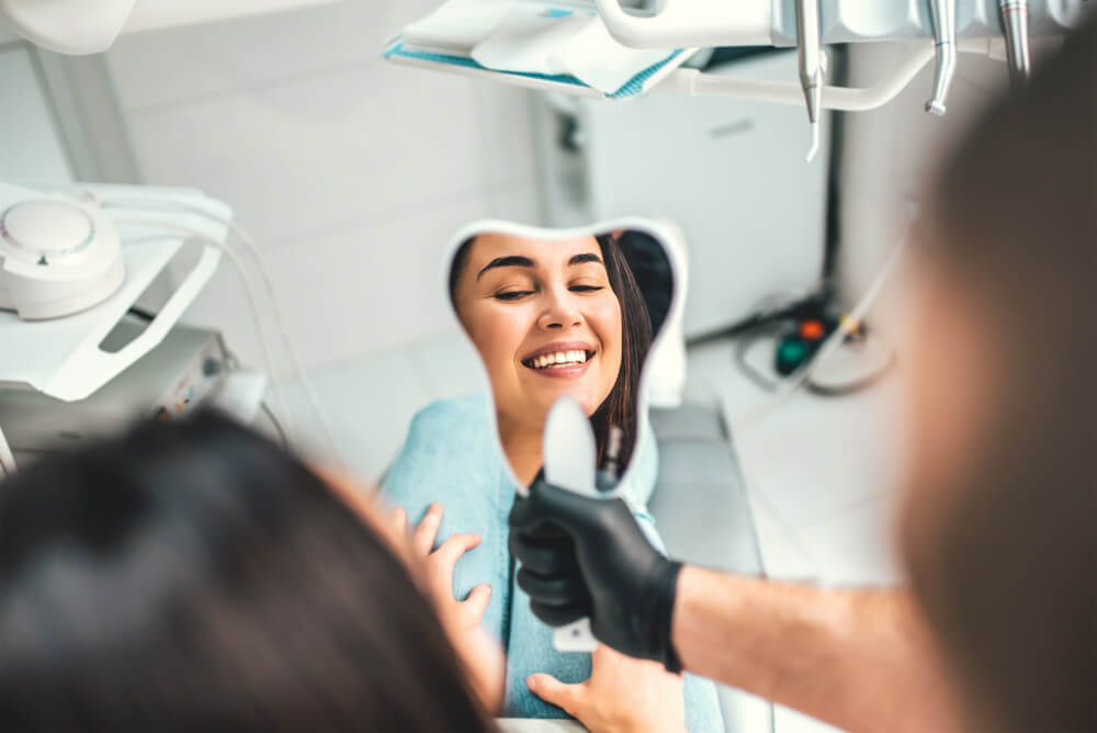 Dentist showing for the patient result of treatment