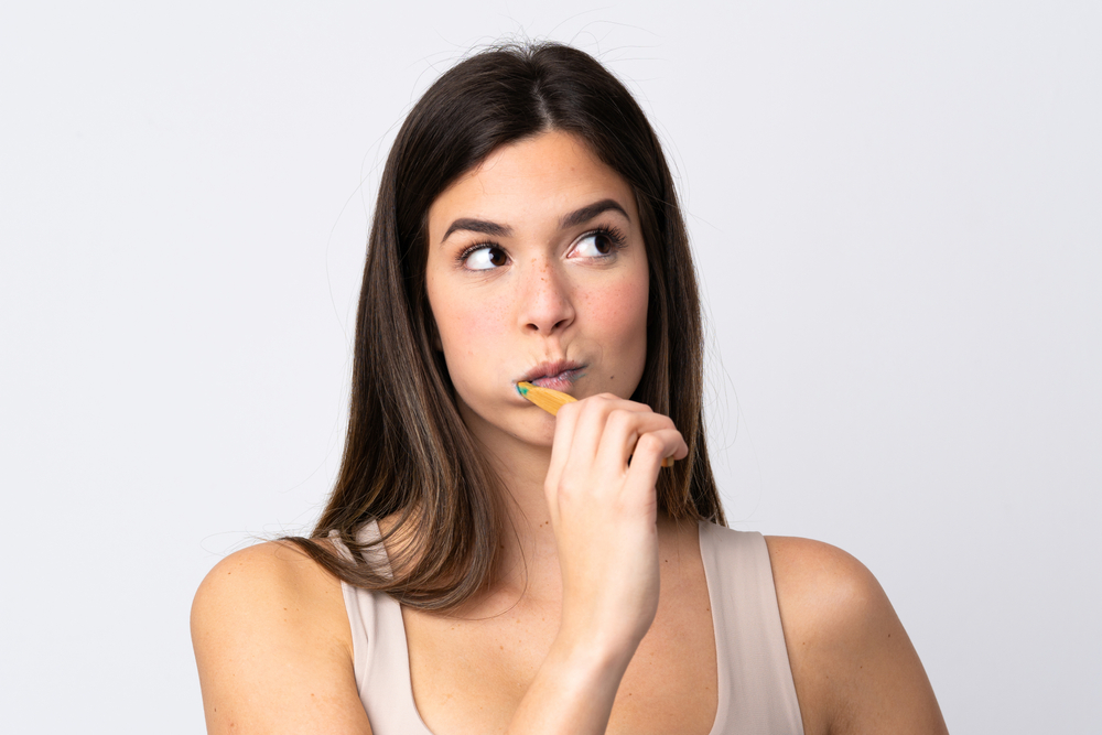Teenager girl brushing her teeth