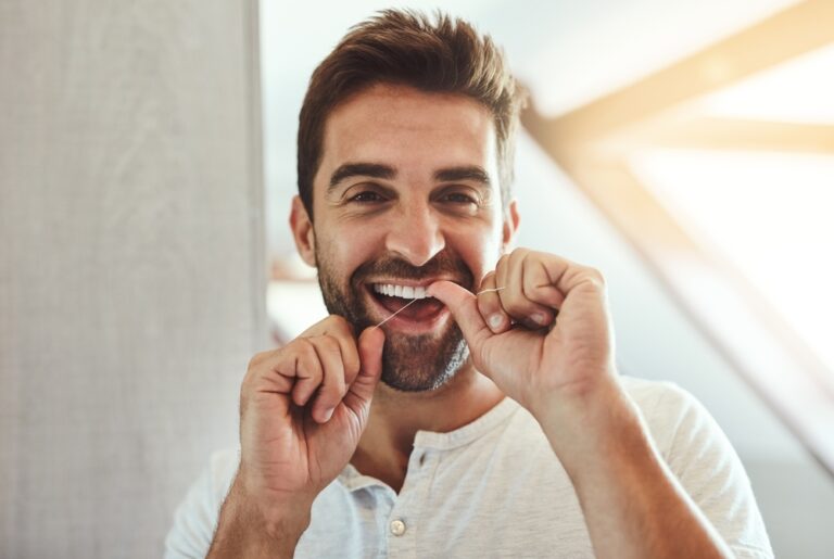 Man flossing at home