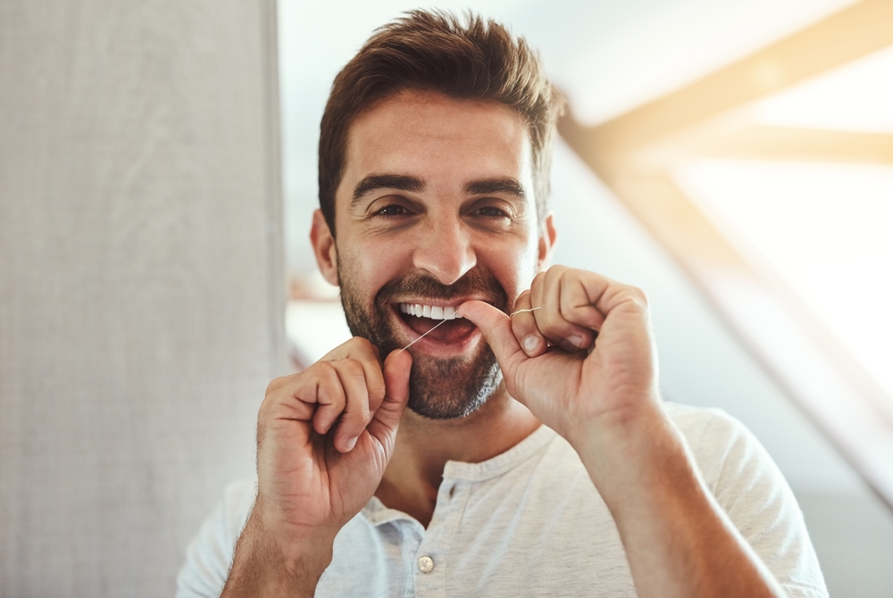 Man flossing at home