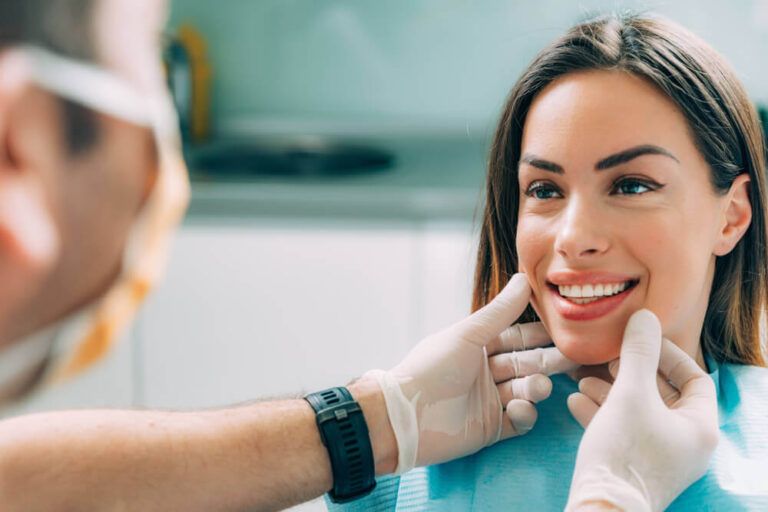 Young smiling woman having a dental inspection