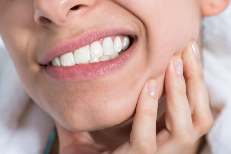 Young woman suffering from toothache